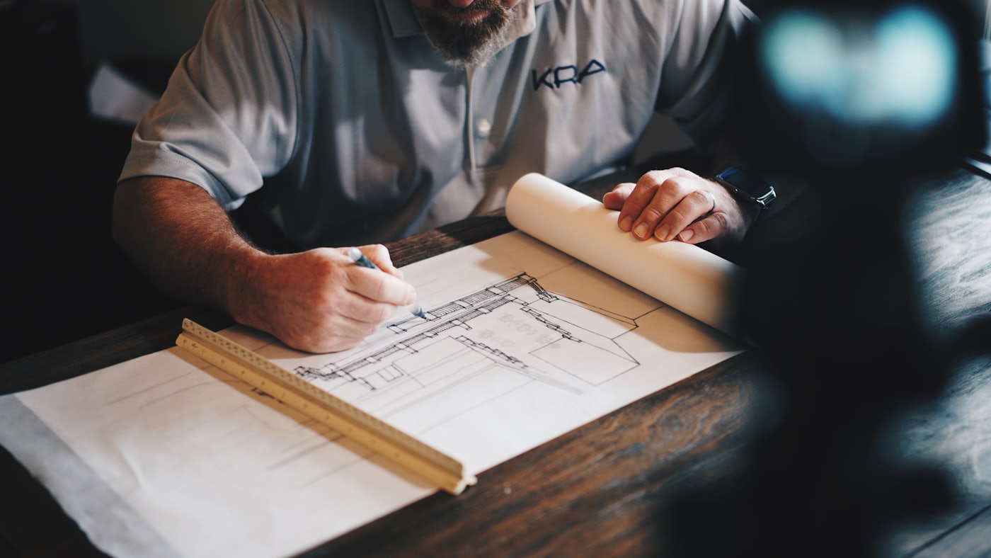 Contractor reviewing architectural plans at a renovation site
